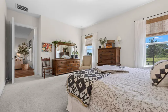 a bedroom with a bed and a dresser