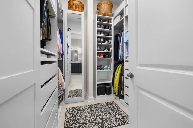 a view of walk in closet with clothes