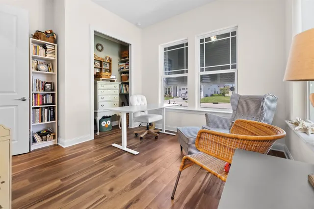 a living room with furniture and a book shelf