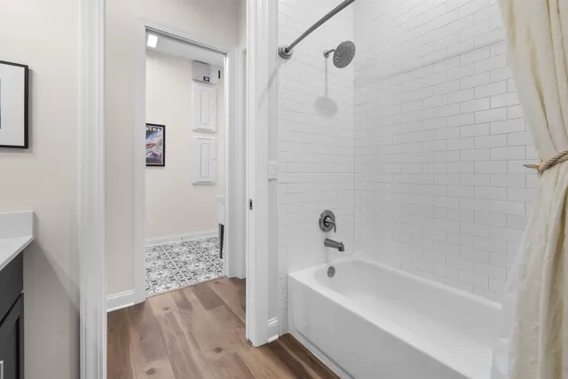 a bathroom with a bathtub and shower