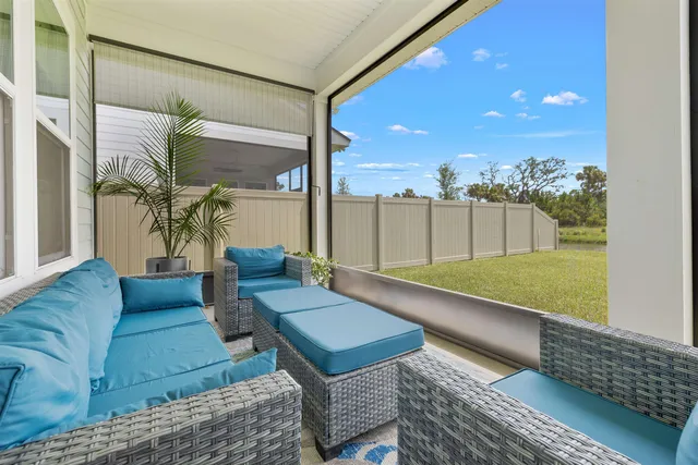 a front view of a house with a garden and trees
