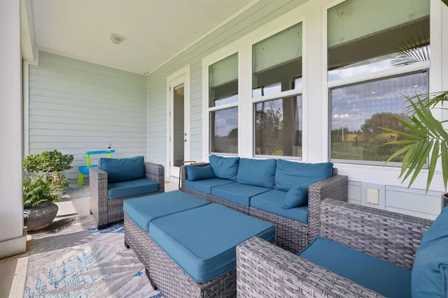 a view of a city with lots of residential buildings ocean and mountain view in back