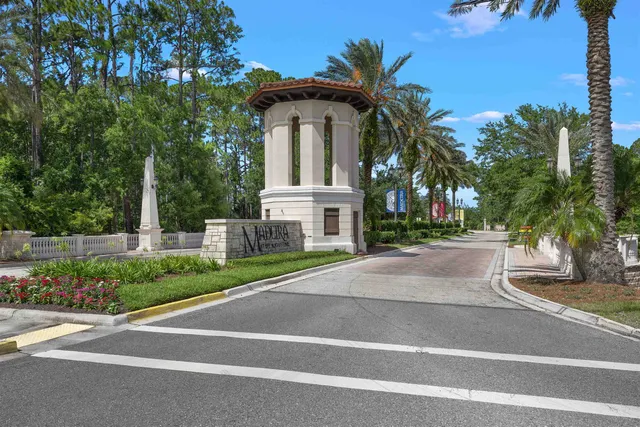 an aerial view of a house with a garden and lake view
