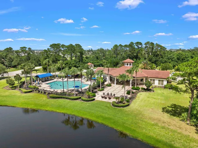a swimming pool with outdoor seating and yard