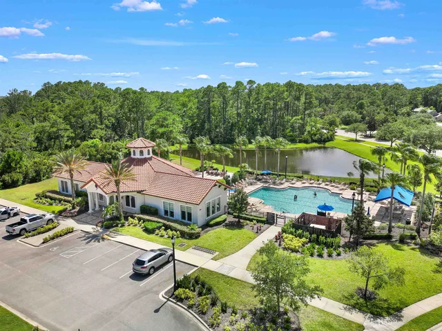 a view of a patio with table and chairs under an umbrella