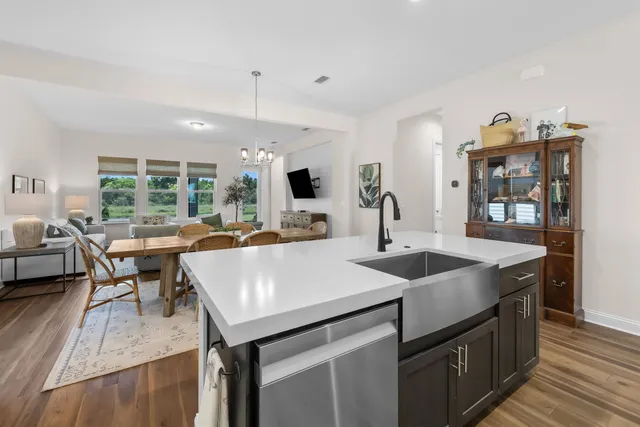 a kitchen with sink and view of living room