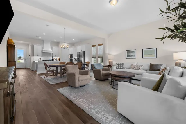 a living room with lots of furniture and a table