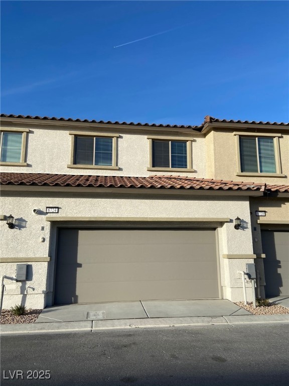 8724 Giant Causeway Avenue Las Vegas, NV 89148 - Photo 4 of 32 Mediterranean / spanish-style house with stucco siding, a garage, and driveway