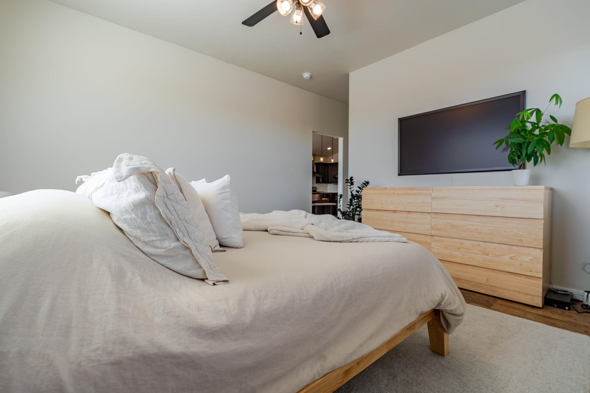 1301 M Road Loma, CO 81524 - Photo 12 of 32 a bedroom with a bed and a chandelier