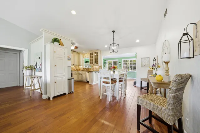 a view of a dining room with furniture wooden floor and a chandelier
