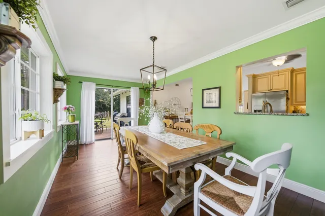 a bedroom with a large bed and wooden floor