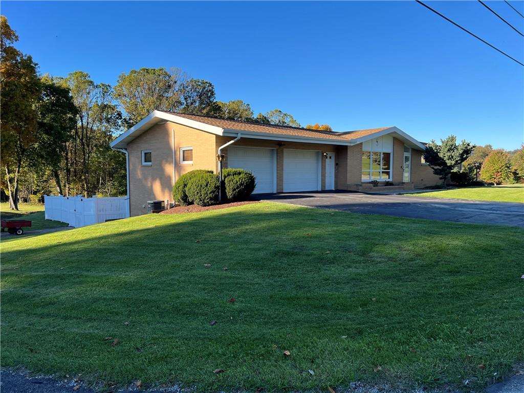 612 College Lodge Road Indiana, PA 15701 - Photo 1 of 31 a front view of a house with a yard and garage