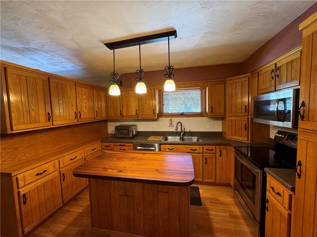 612 College Lodge Road Indiana, PA 15701 - Photo 5 of 31 a kitchen with stainless steel appliances granite countertop a sink a stove counter space and cabinets
