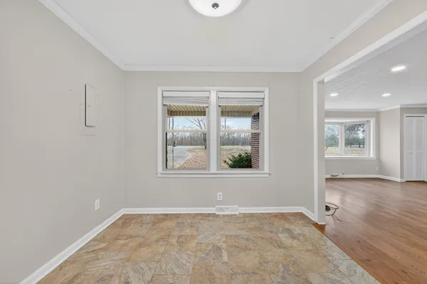 an empty room with windows and closet
