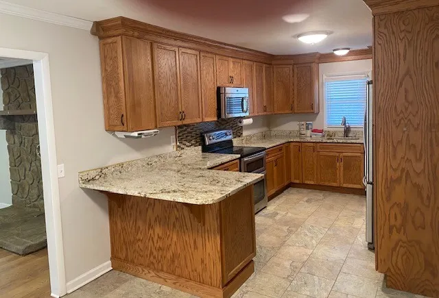 a kitchen with a sink stove and cabinets