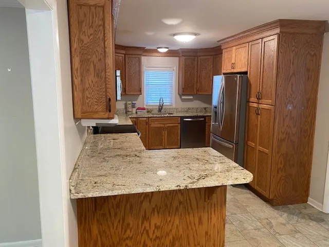 a kitchen with a refrigerator and a stove
