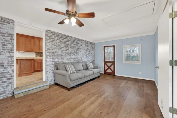 a living room with furniture and a ceiling fan