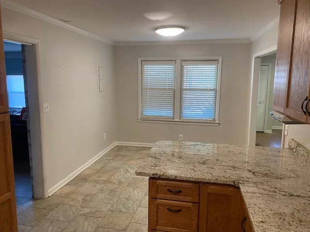 a bathroom with a granite countertop sink and mirror