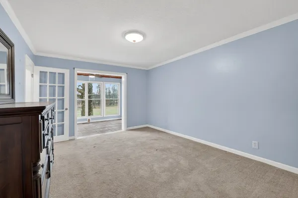 an empty room with a fireplace and windows