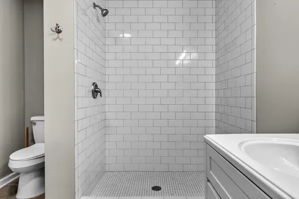 a bathroom with a double vanity sink a mirror and a bathtub