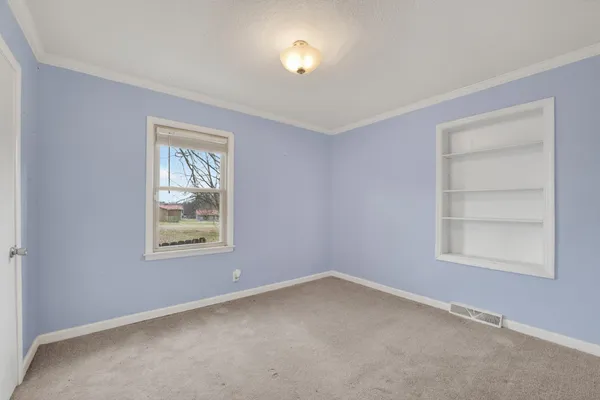 a view of kitchen with stainless steel appliances a refrigerator and cabinets