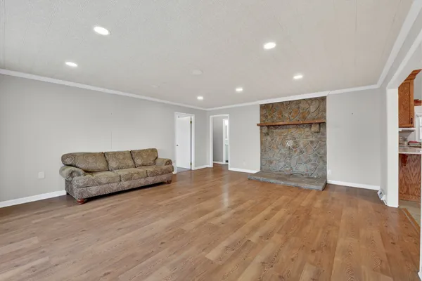 a living room with a couch and a wooden floor