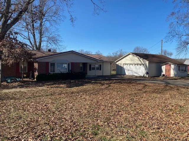 a view of house with a yard