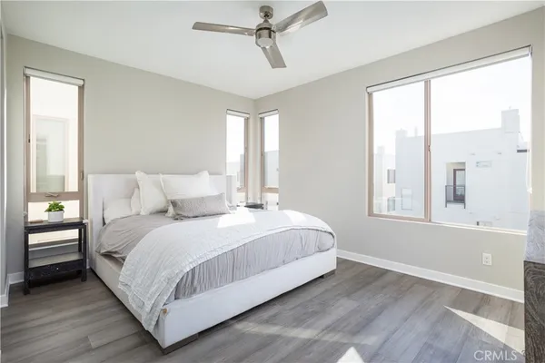 a bedroom with a bed lamp and window
