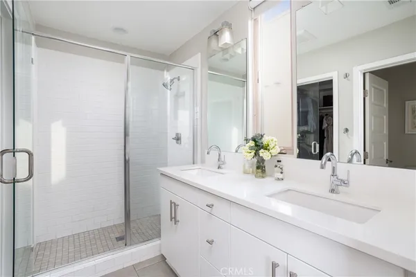 a bathroom with a double vanity sink and a mirror