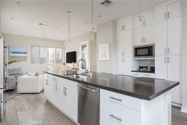 a kitchen with stainless steel appliances granite countertop a sink and a stove