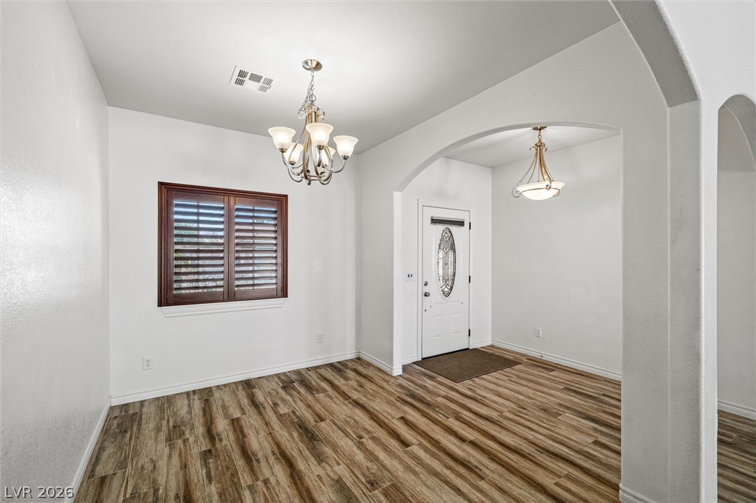 6720 Stubblefield Drive Pahrump, NV 89061 - Photo 6 of 51 Hardwood-style tile flooring and graceful archways welcome guests into this open, naturally lit living space.