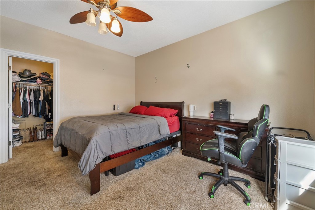 7172 Jargon Road Hesperia, CA 92344 - Photo 32 of 75 a bedroom with a bed and a desk