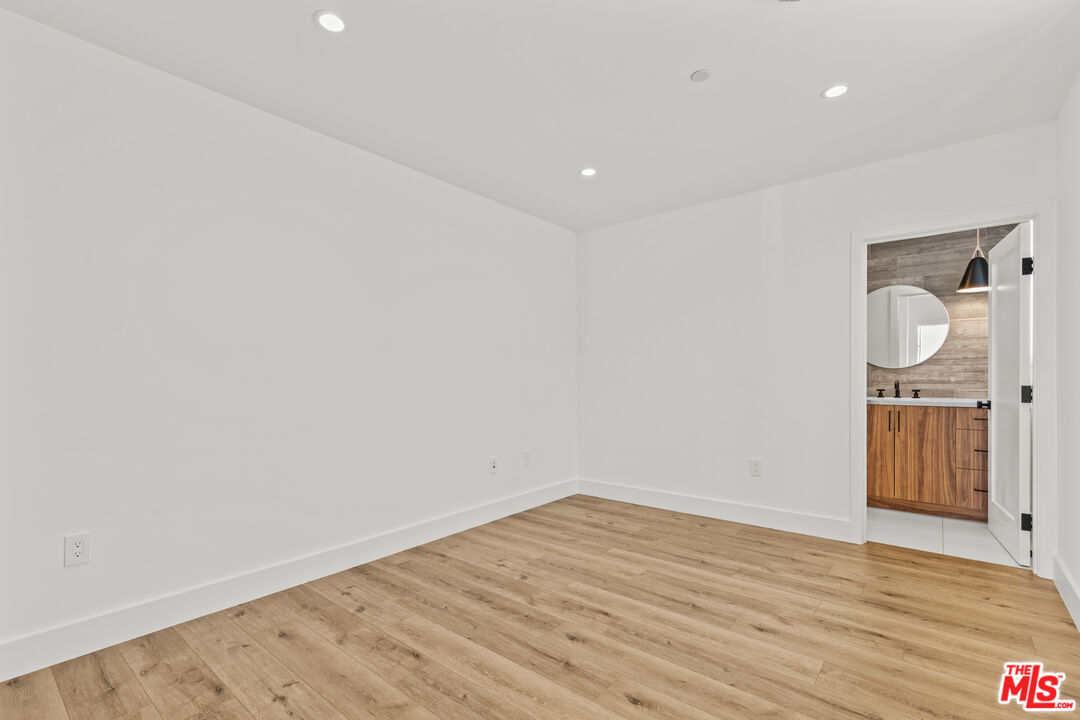 5536 Tova Road Sherman Oaks, CA 91411 - Photo 11 of 15 a view of a room with wooden floor and white walls