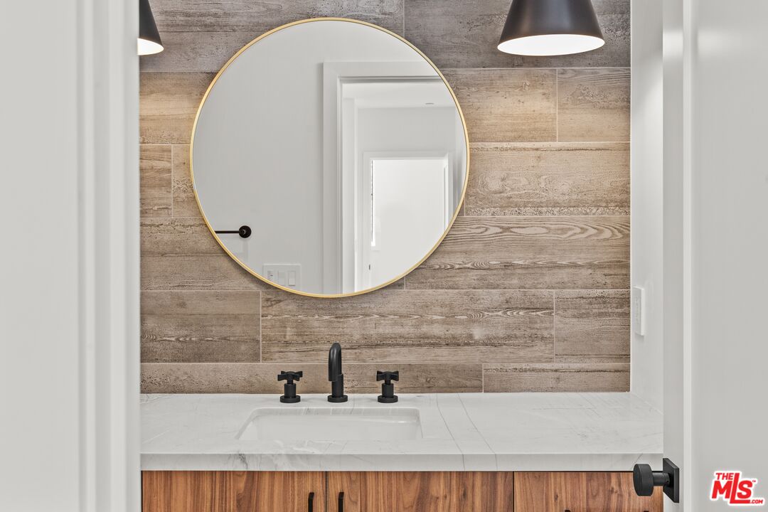 5536 Tova Road Sherman Oaks, CA 91411 - Photo 12 of 15 a bathroom with a sink a mirror and vanity