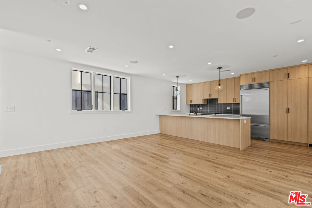 5536 Tova Road Sherman Oaks, CA 91411 - Photo 2 of 15 a large kitchen with stainless steel appliances granite countertop a stove a sink and a refrigerator
