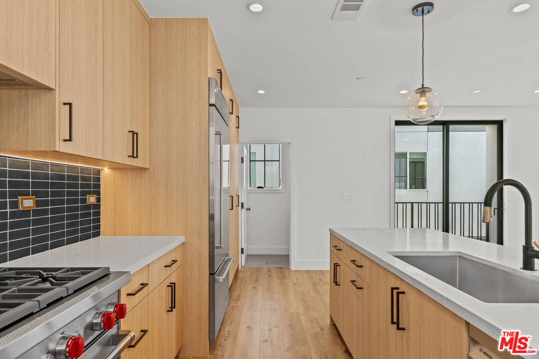 5536 Tova Road Sherman Oaks, CA 91411 - Photo 4 of 15 a open kitchen with stainless steel appliances granite countertop a sink stove and refrigerator