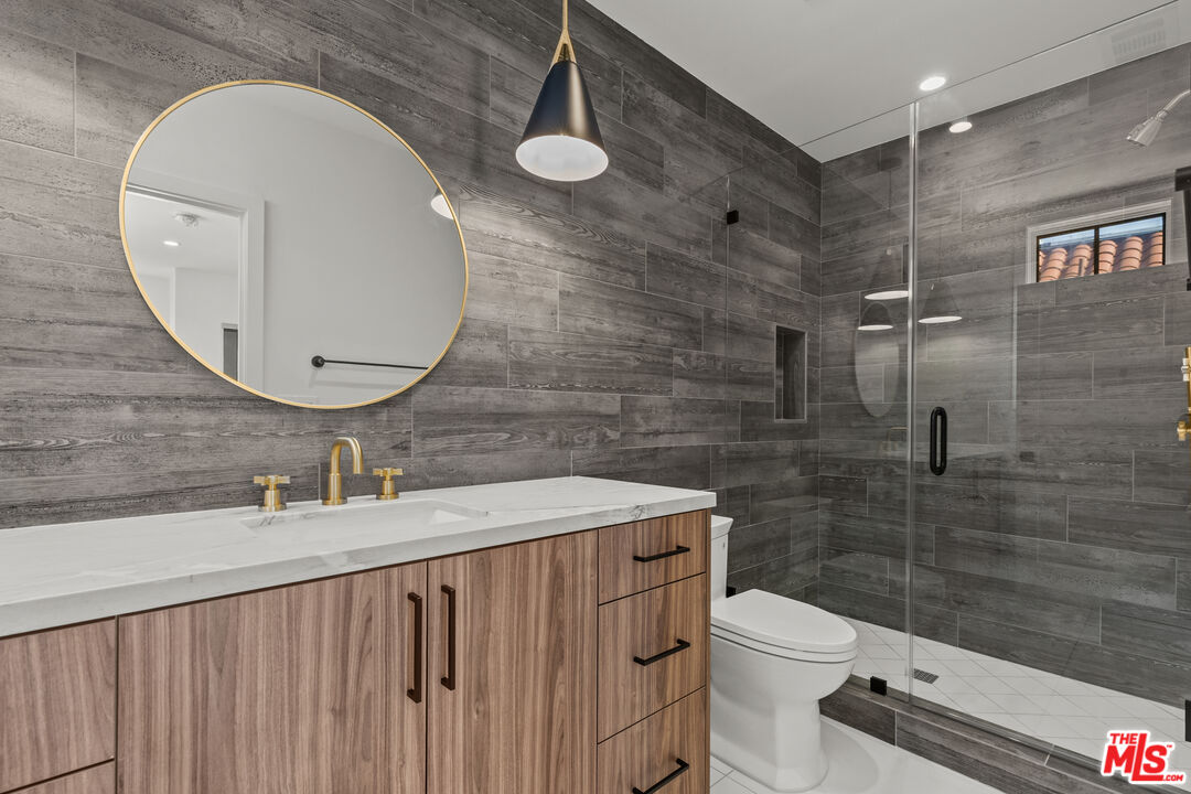 5536 Tova Road Sherman Oaks, CA 91411 - Photo 8 of 15 a bathroom with a sink a toilet and shower