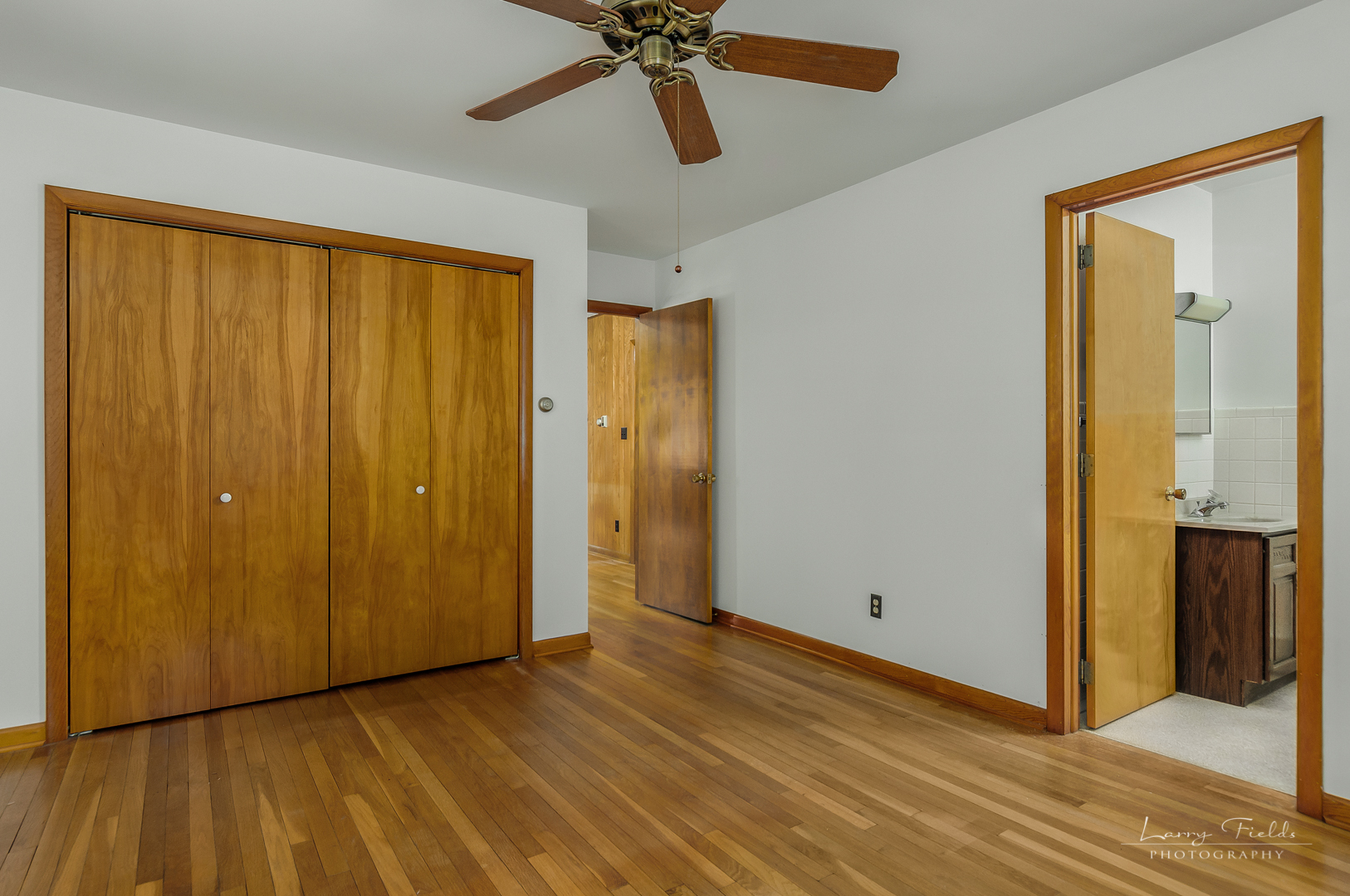 4682 East 29th Road Sandwich, IL 60548 - Photo 6 of 18 a view of an empty room with wooden floor and a ceiling fan