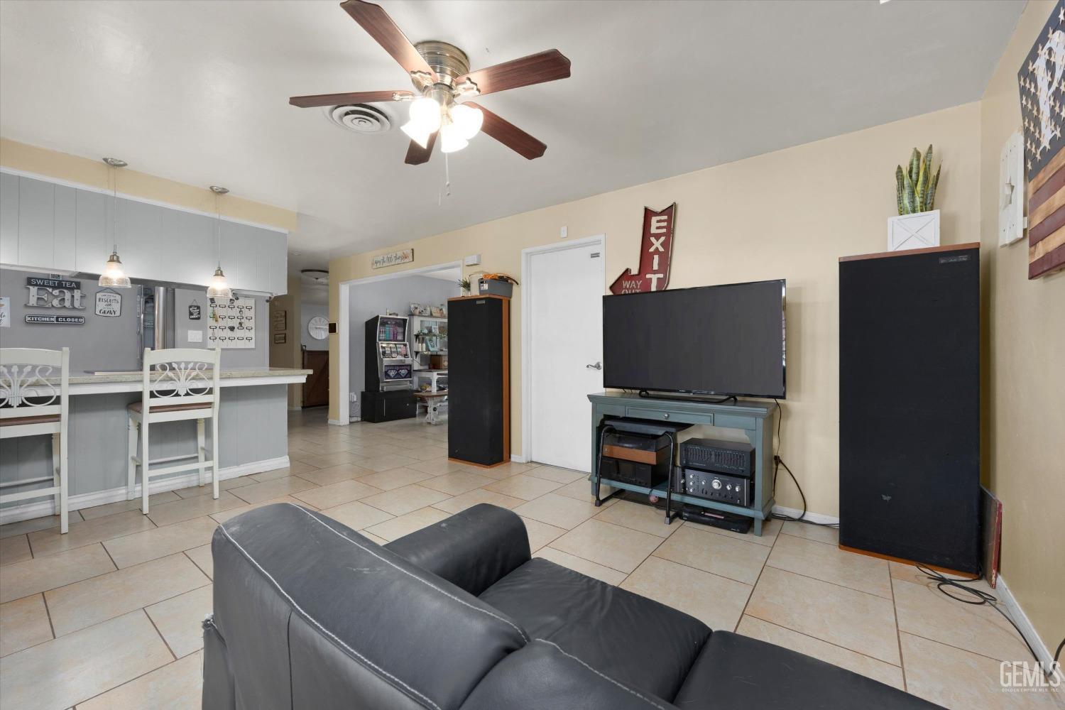 Undisclosed Address Bakersfield, CA 93309 - Photo 16 of 33 a living room with furniture a flat screen tv and kitchen view
