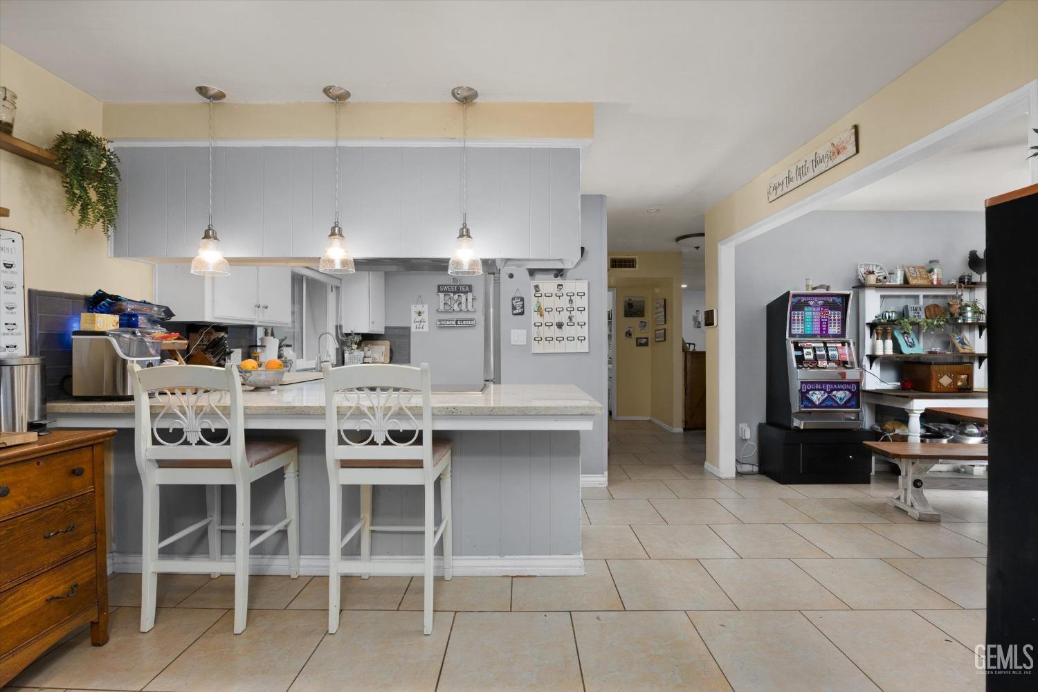 Undisclosed Address Bakersfield, CA 93309 - Photo 17 of 33 a kitchen with stainless steel appliances kitchen island granite countertop a table and chairs in it
