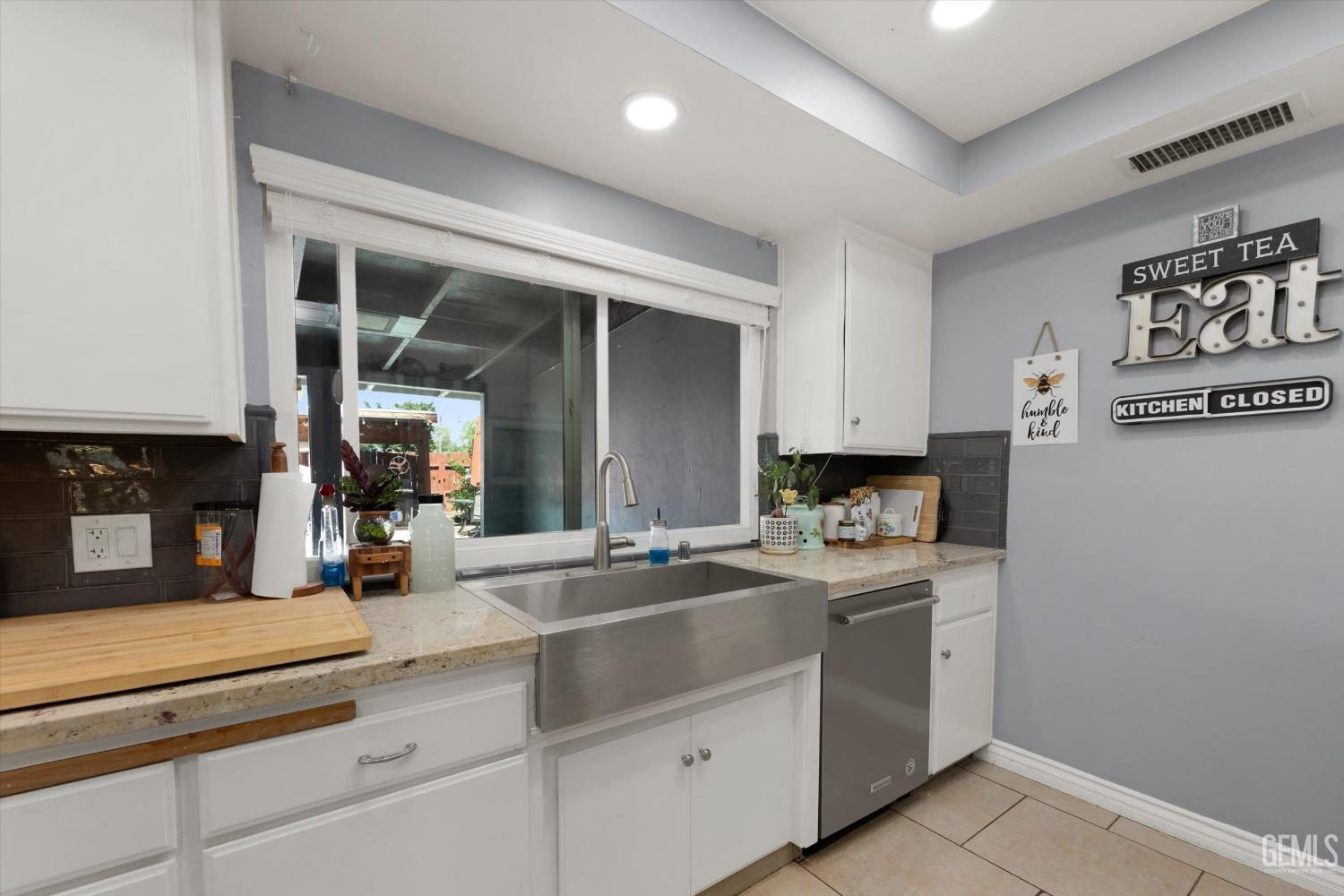 Undisclosed Address Bakersfield, CA 93309 - Photo 20 of 33 a kitchen with sink a stove and cabinets