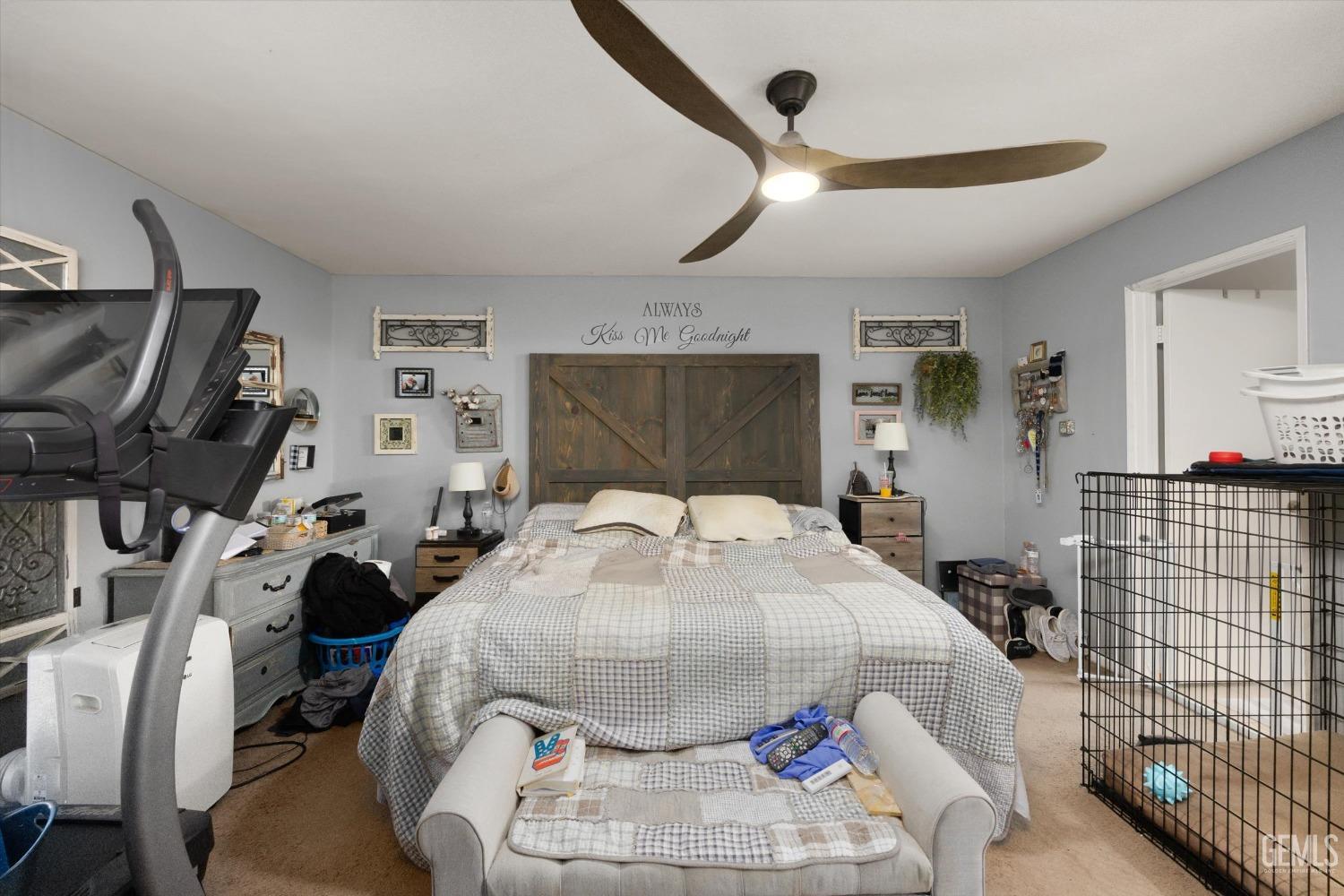 Undisclosed Address Bakersfield, CA 93309 - Photo 23 of 33 a bedroom with a bed and a flat tv screen on the dresser