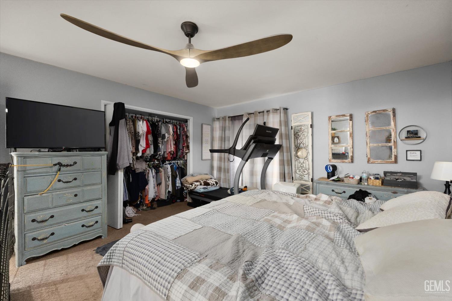 Undisclosed Address Bakersfield, CA 93309 - Photo 24 of 33 a bedroom with a bed and a flat tv screen on dresser
