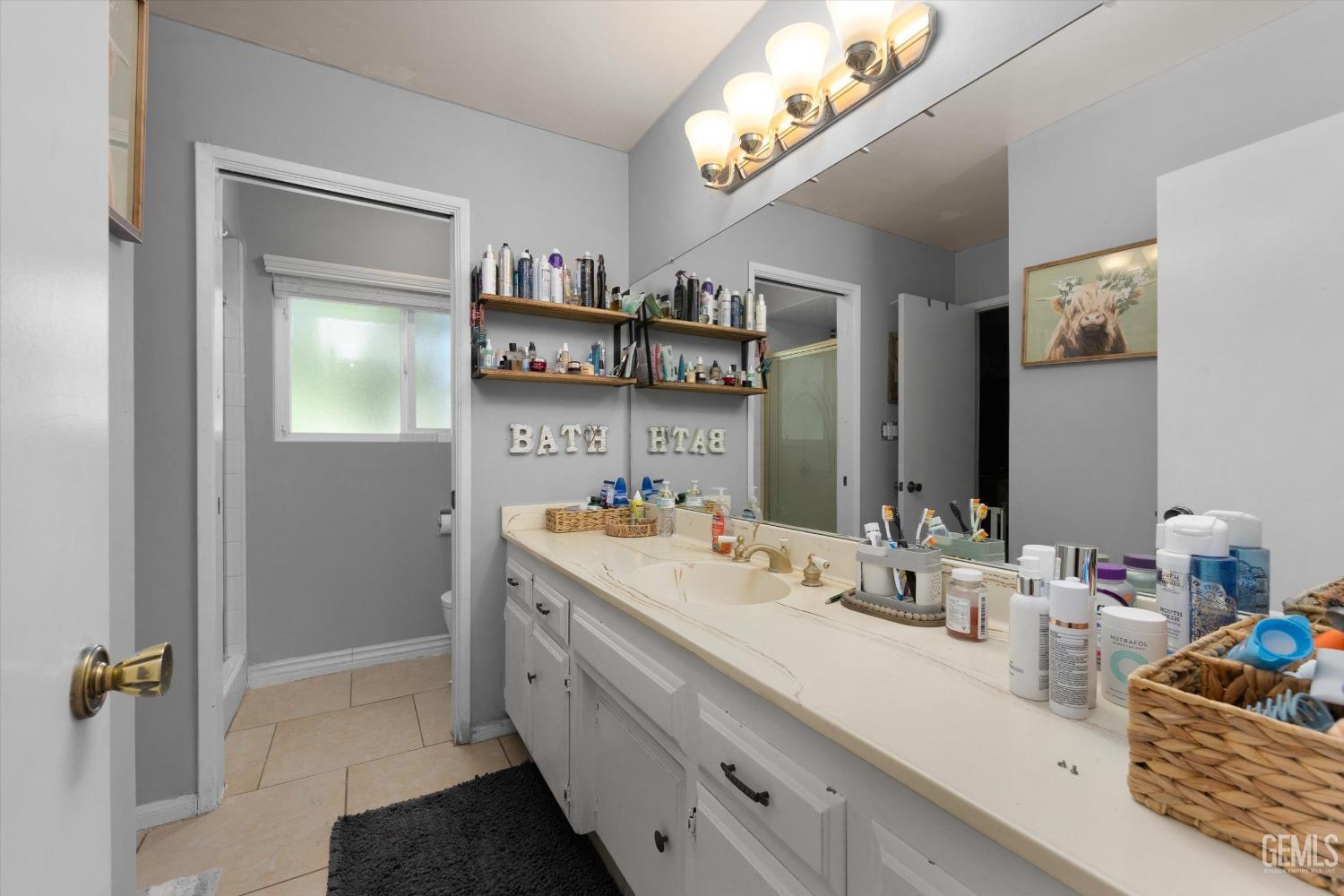 Undisclosed Address Bakersfield, CA 93309 - Photo 25 of 33 a bathroom with a sink double vanity and a mirror