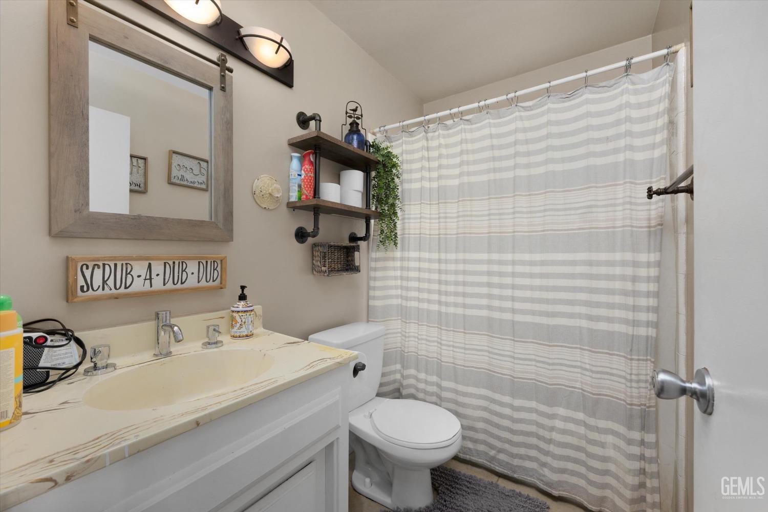 Undisclosed Address Bakersfield, CA 93309 - Photo 28 of 33 a bathroom with a sink a toilet and shower