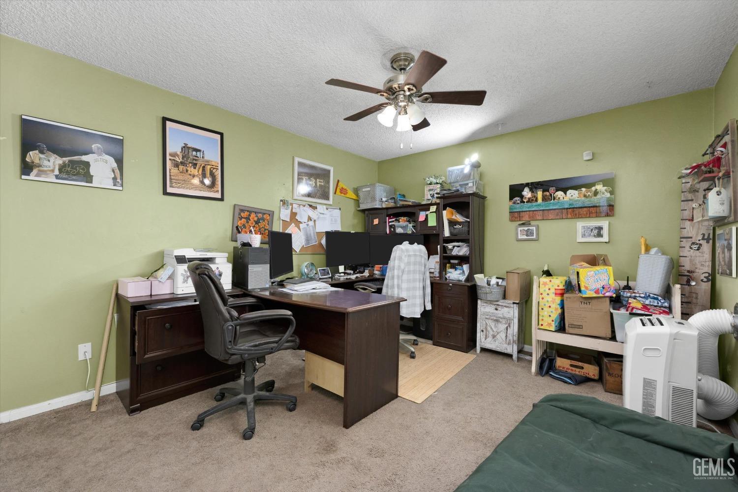 Undisclosed Address Bakersfield, CA 93309 - Photo 29 of 33 a view of a workspace with furniture and a ceiling fan
