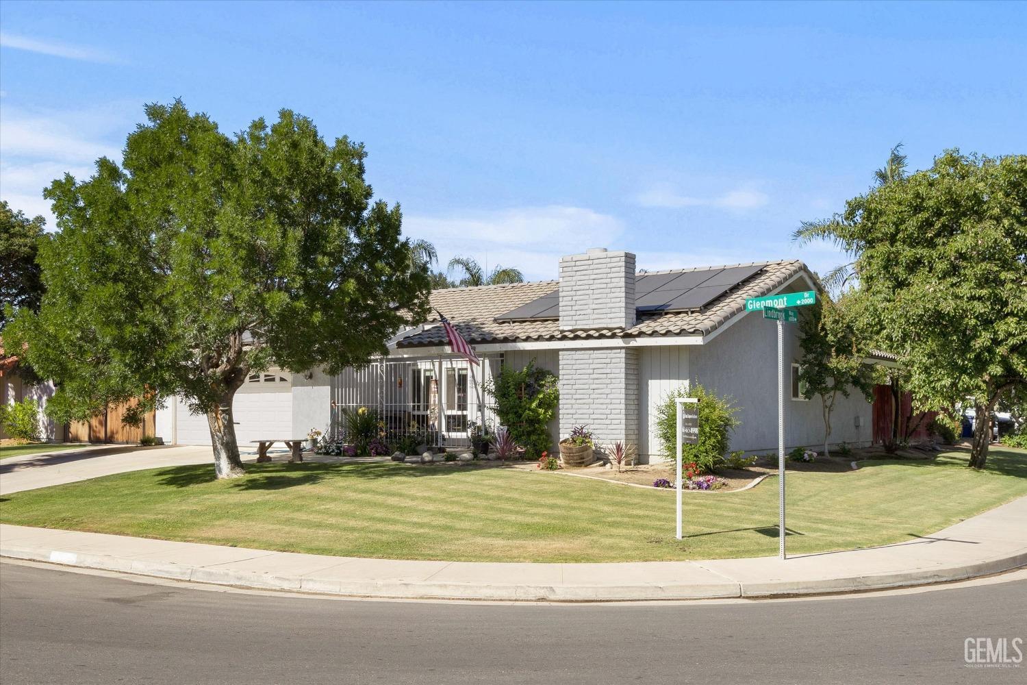 Undisclosed Address Bakersfield, CA 93309 - Photo 3 of 33 a view of a white house with a small yard and potted plants