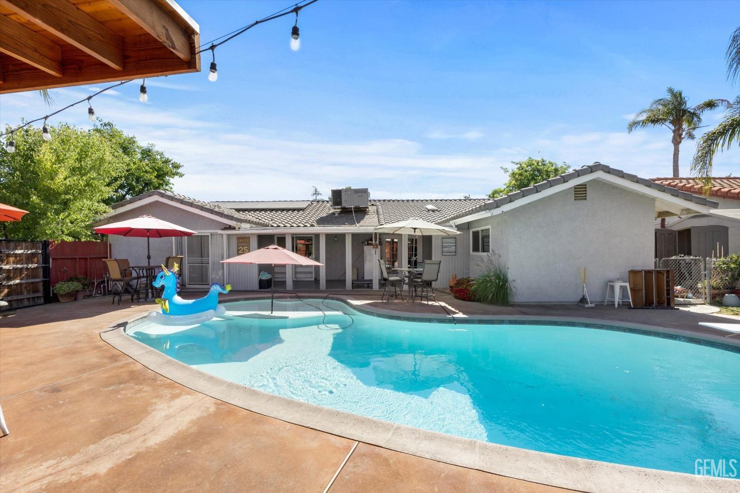 Undisclosed Address Bakersfield, CA 93309 - Photo 31 of 33 a front view of a house with swimming pool patio and fire pit