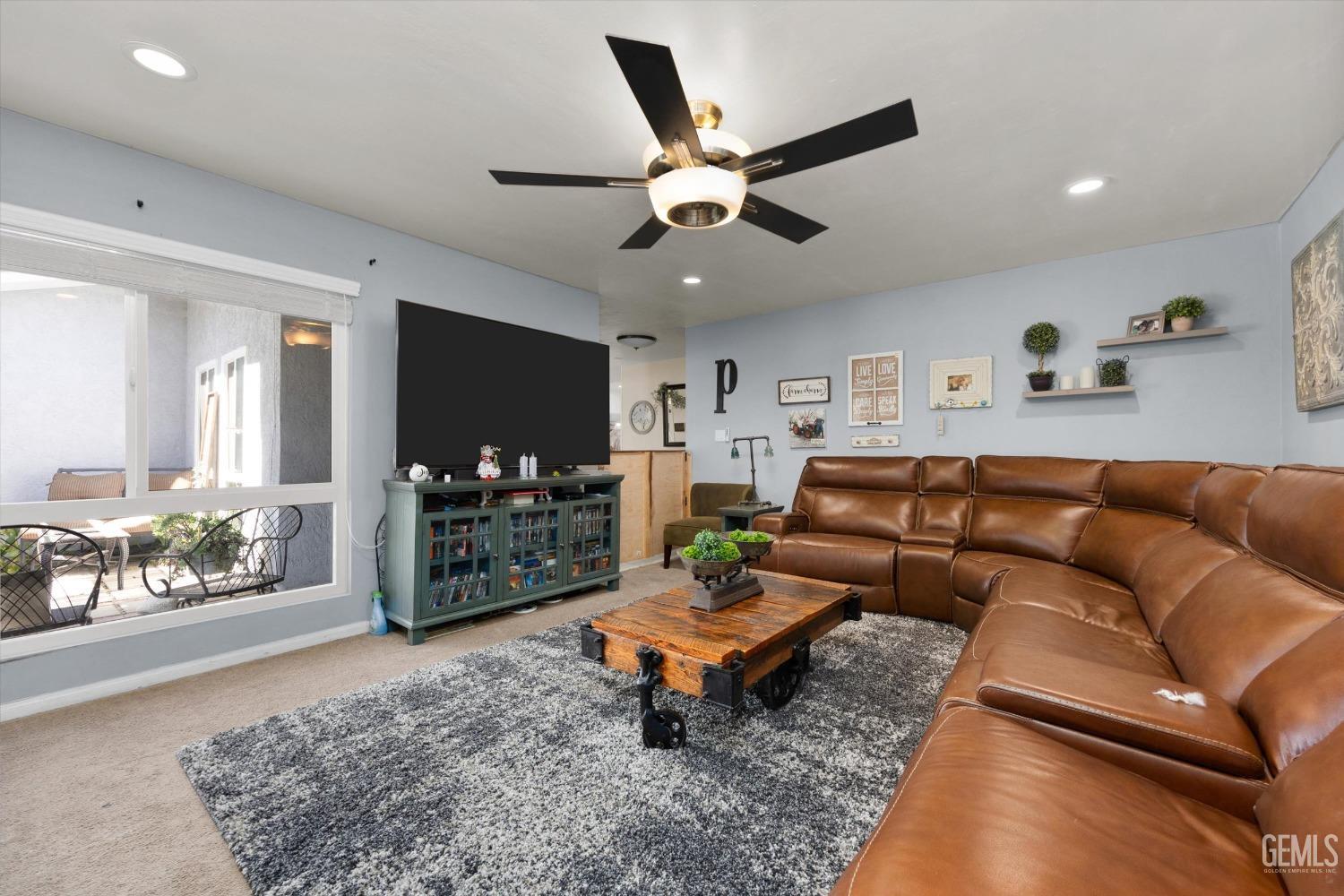 Undisclosed Address Bakersfield, CA 93309 - Photo 7 of 33 a living room with furniture and a flat screen tv