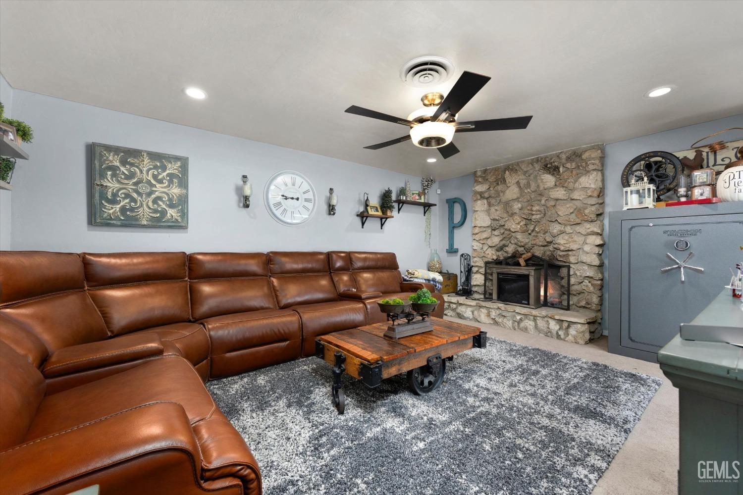 Undisclosed Address Bakersfield, CA 93309 - Photo 9 of 33 a living room with furniture a fireplace and a flat screen tv